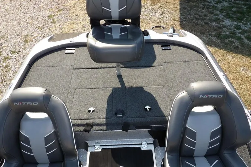 Slide: The Image of 2023 Nitro Z19 boat interior with gray seating and carpeted deck. - 13