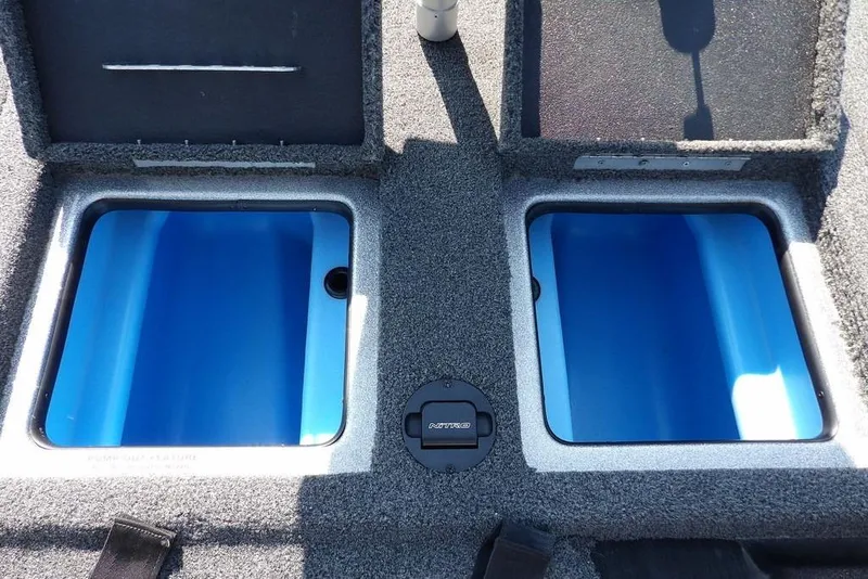 Slide: The Image of 2023 Nitro Z19 boat storage compartments with open lids, showcasing blue interior. - 17