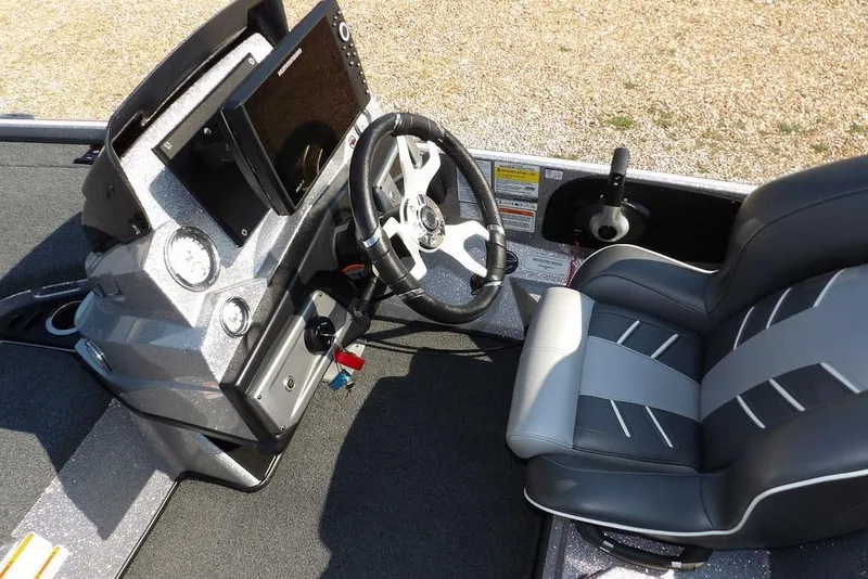 Slide: The Image of 2023 Nitro Z19 boat cockpit with steering wheel, dashboard, and comfortable seating. - 18
