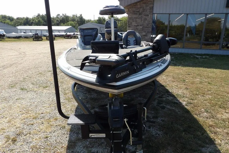 Slide: The Image of 2023 Nitro Z19 boat with Garmin equipment, parked outdoors near a building. - 2