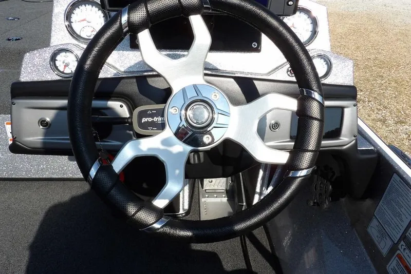Slide: The Image of Steering wheel of a 2023 Nitro Z19 boat with dashboard controls. - 25