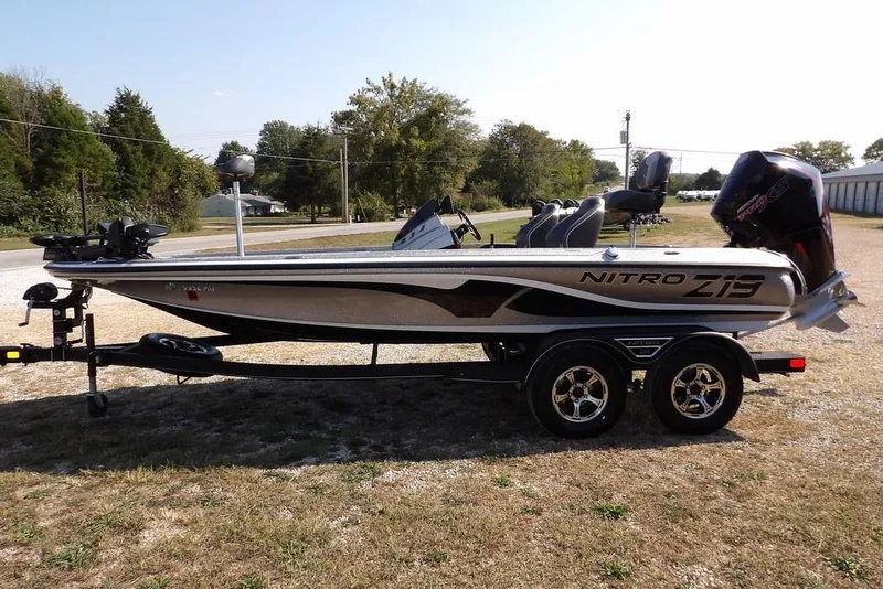 Slide: The Image of 2023 Nitro Z19 boat on trailer, parked outdoors, side view. - 3