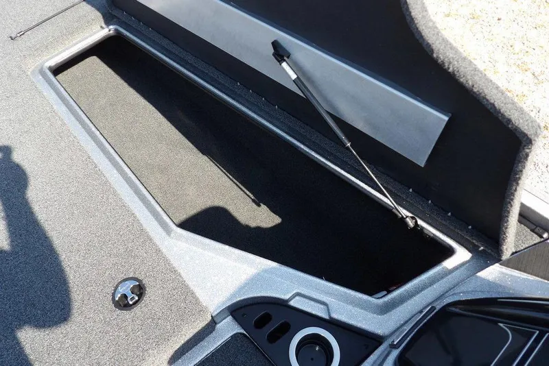 Slide: The Image of Open storage compartment in 2023 Nitro Z19 boat, featuring carpeted interior and hydraulic lift. - 32