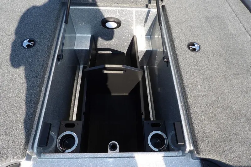 Slide: The Image of 2023 Nitro Z19 boat storage compartment with cup holders and carpeted interior. - 34