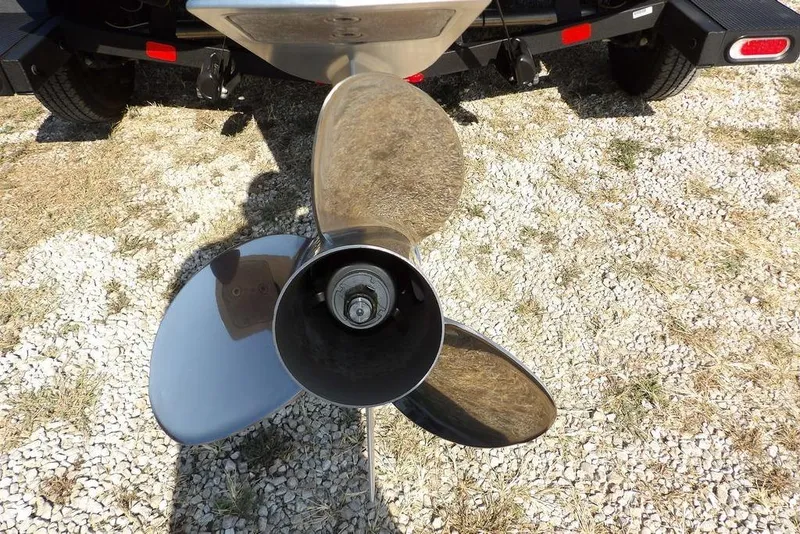 Slide: The Image of 2023 Nitro Z19 boat propeller on gravel surface, showcasing shiny metal blades. - 38