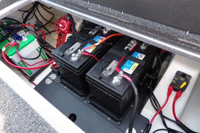 Slide: The Image of 2023 Nitro Z19 boat battery compartment with multiple batteries and wiring setup. - 41