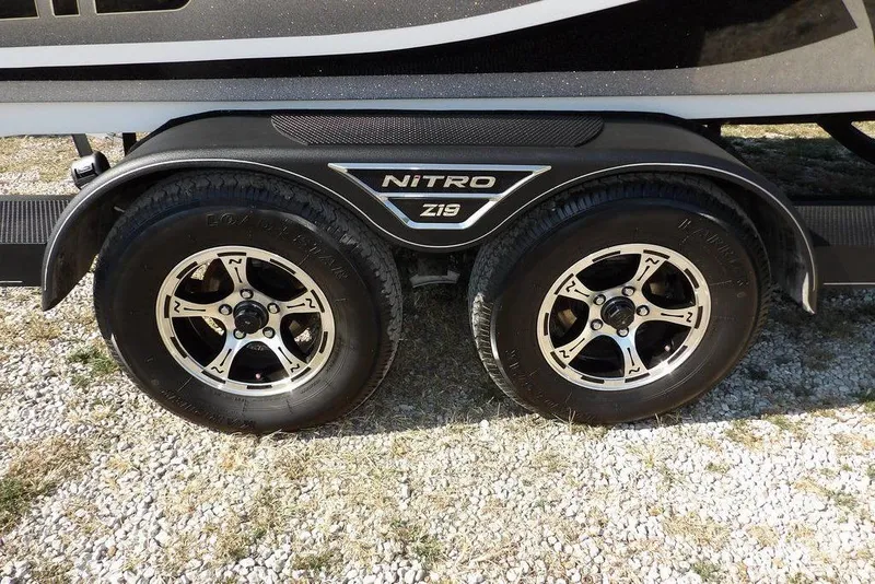 Slide: The Image of 2023 Nitro Z19 trailer wheels on gravel, showcasing dual tires and sleek design. - 45
