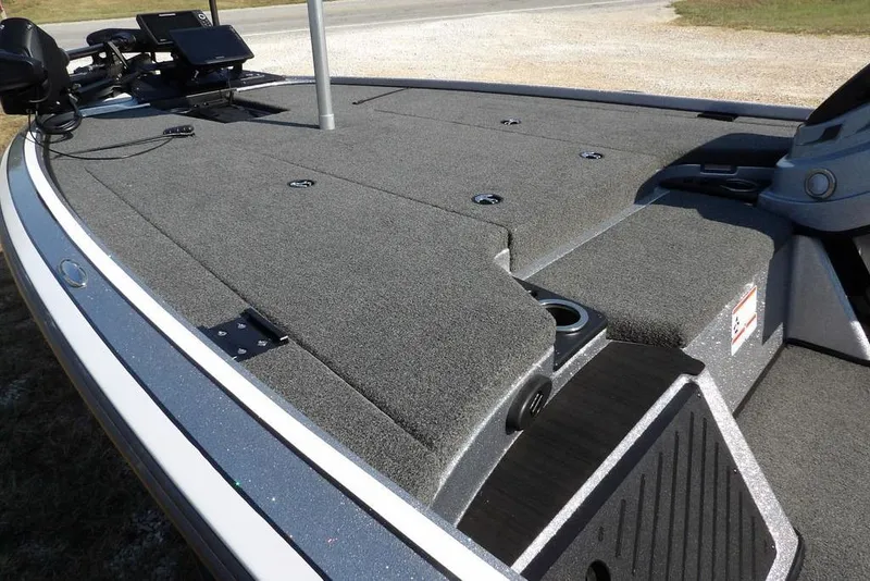 Slide: The Image of 2023 Nitro Z19 boat deck with fishing equipment and carpeted surface. - 6