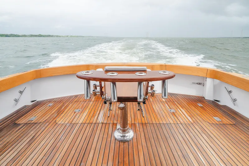 Slide: The Image of 2005 Hatteras Convertible 60 yacht deck with wooden flooring and ocean view. - 10