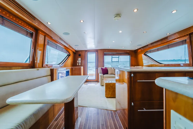 Slide: The Image of Luxurious interior of 2005 Hatteras Convertible 60 yacht with elegant wood finishes and spacious seating. - 12