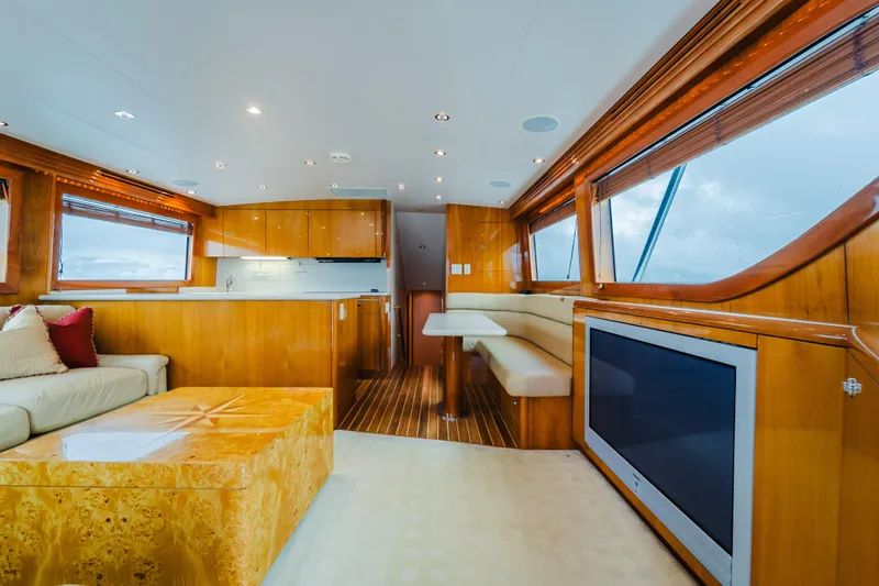 Slide: The Image of Luxurious interior of 2005 Hatteras Convertible 60 yacht with modern furnishings and large windows. - 16
