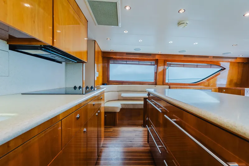 Slide: The Image of Luxurious interior of 2005 Hatteras Convertible 60 yacht with modern kitchen and seating area. - 18