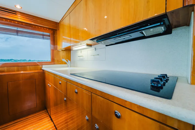 Slide: The Image of Luxurious kitchen interior of 2005 Hatteras Convertible 60 yacht with sleek wooden cabinetry. - 20