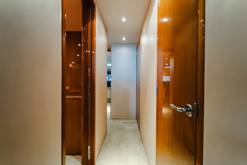 Slide: The Image of Interior hallway of 2005 Hatteras Convertible 60 yacht with wooden doors and modern lighting. - 22