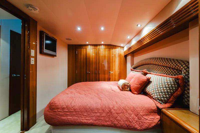 Slide: The Image of Luxurious bedroom interior of 2005 Hatteras Convertible 60 yacht with elegant wood finishes. - 24