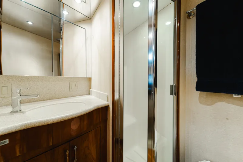 Slide: The Image of Luxurious bathroom in 2005 Hatteras Convertible 60 yacht with modern fixtures and shower. - 28