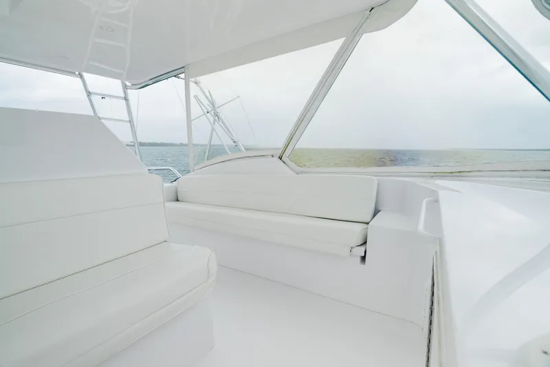 Slide: The Image of Luxurious interior of 2005 Hatteras Convertible 60 yacht with white seating and ocean view. - 33
