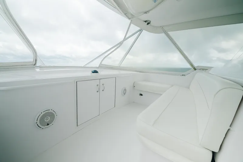 Slide: The Image of 2005 Hatteras Convertible 60 yacht interior with white seating and storage cabinets. - 41