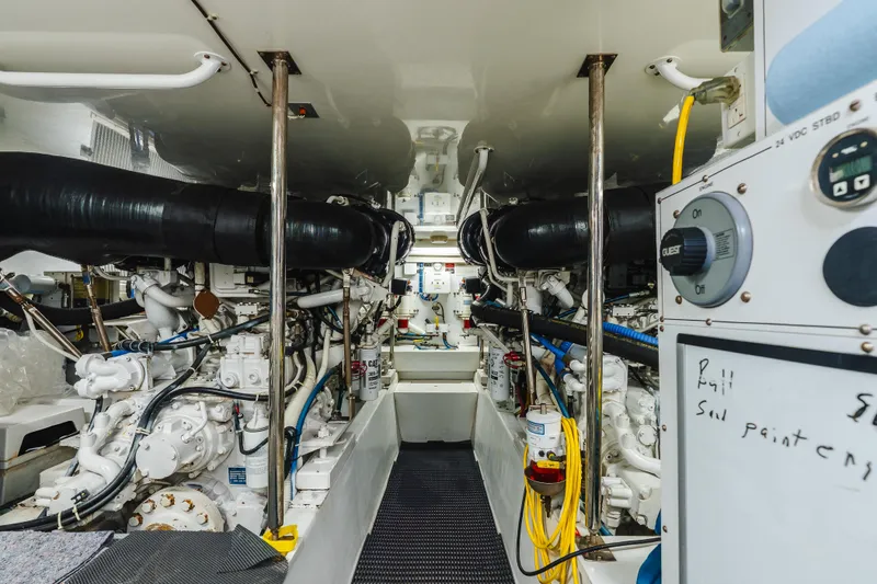 Slide: The Image of Engine room of 2005 Hatteras Convertible 60 yacht, showcasing machinery and equipment. - 42