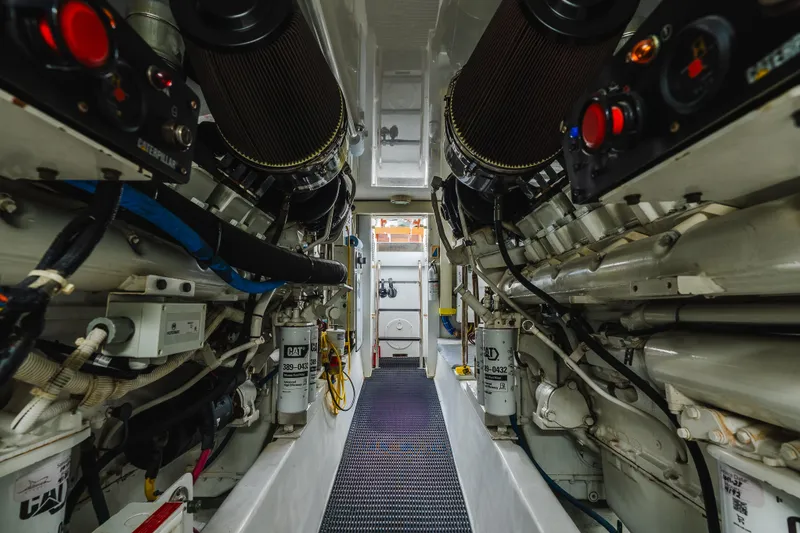 Slide: The Image of Engine room of 2005 Hatteras Convertible 60 yacht, showcasing mechanical components and systems. - 43