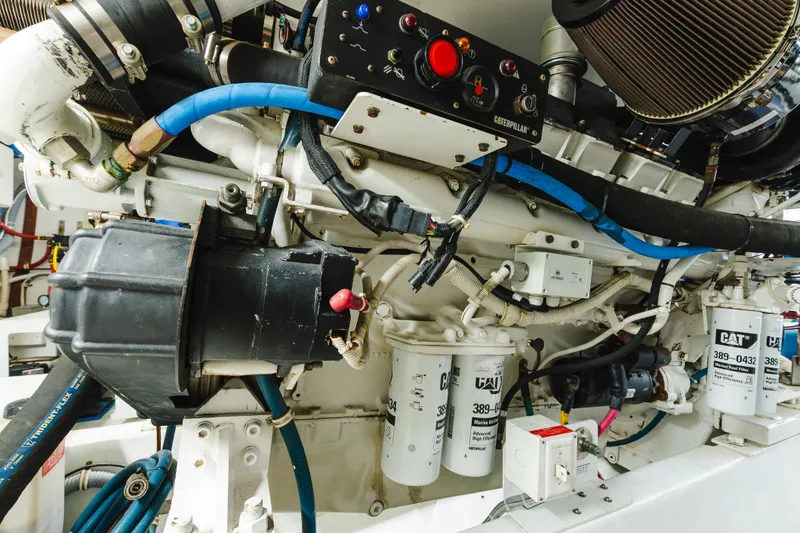 Slide: The Image of Engine room of a 2005 Hatteras Convertible 60 yacht, featuring Caterpillar components. - 44