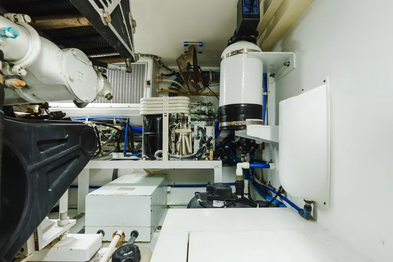 Slide: The Image of Engine room of 2005 Hatteras Convertible 60 yacht, showcasing mechanical components and systems. - 47