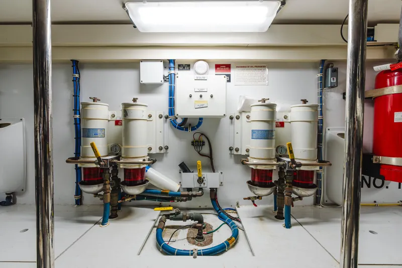 Slide: The Image of Engine room of 2005 Hatteras Convertible 60 yacht with fuel filters and control panel. - 48