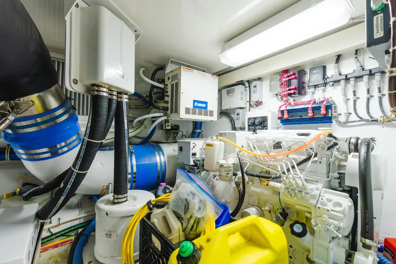 Slide: The Image of Engine room of 2005 Hatteras Convertible 60 yacht, showcasing mechanical components and wiring. - 49