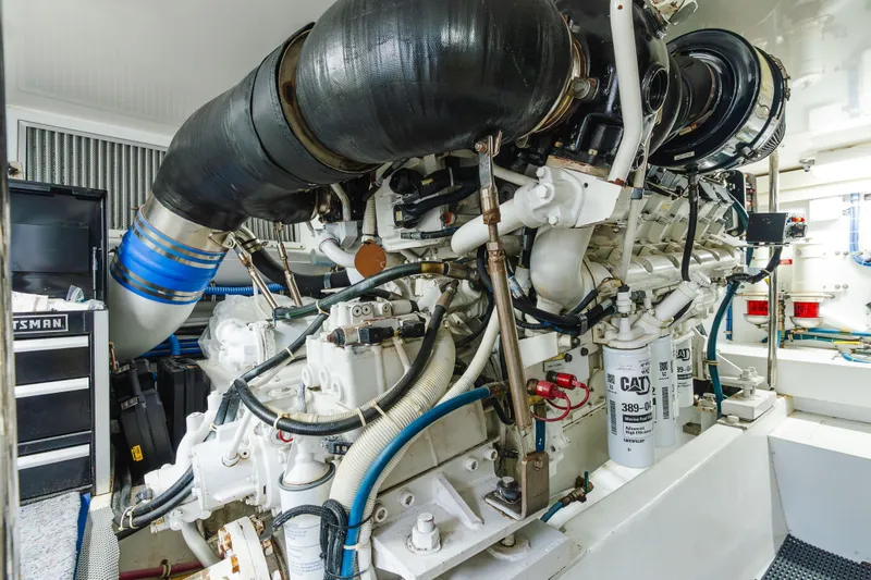 Slide: The Image of Engine room of 2005 Hatteras Convertible 60 yacht, showcasing complex machinery and components. - 50