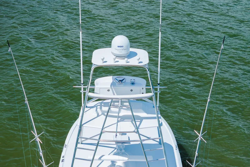 Slide: The Image of 2005 Hatteras Convertible 60 yacht, aerial view, on green water. - 54