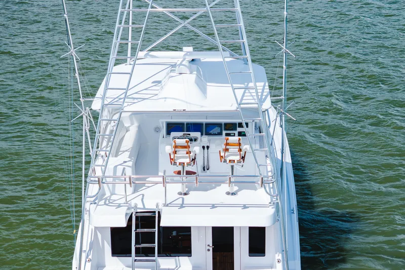 Slide: The Image of 2005 Hatteras Convertible 60 yacht with flybridge on open water. - 56
