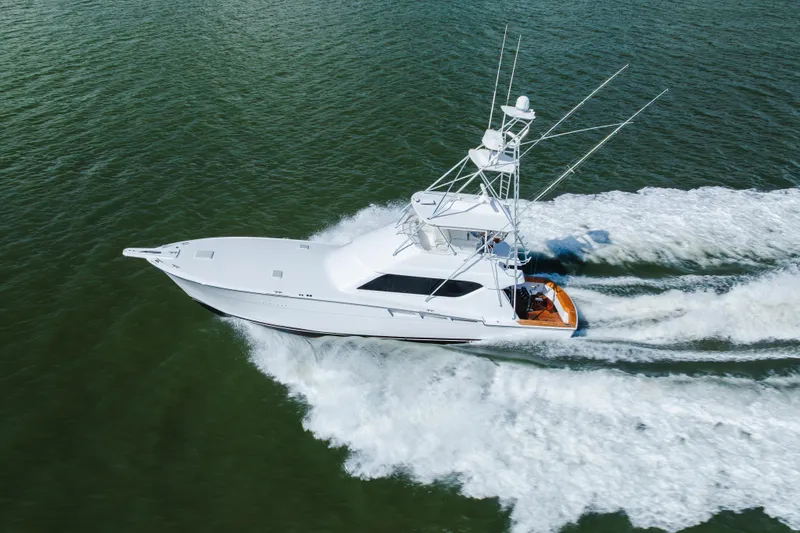 Slide: The Image of 2005 Hatteras Convertible 60 yacht cruising on open water, aerial view. - 61