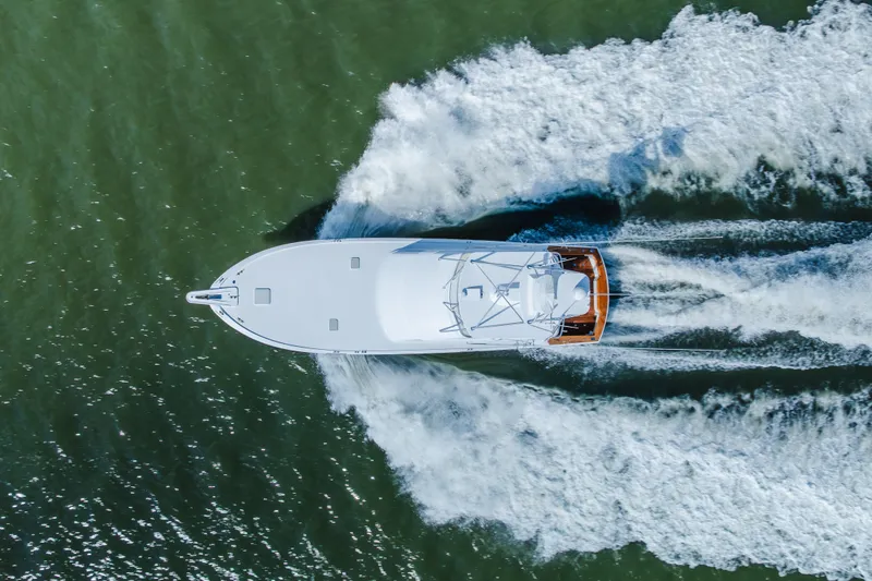 Slide: The Image of Aerial view of 2005 Hatteras Convertible 60 yacht cruising on water. - 63