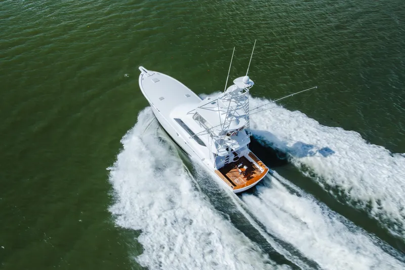Slide: The Image of Aerial view of 2005 Hatteras Convertible 60 yacht cruising on open water. - 64