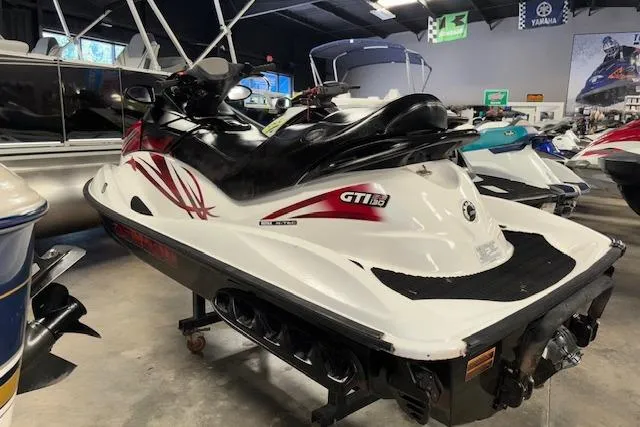 Slide: The Image of 2008 Sea-Doo GTI SE 130 jet ski in showroom, white with red accents. - 6