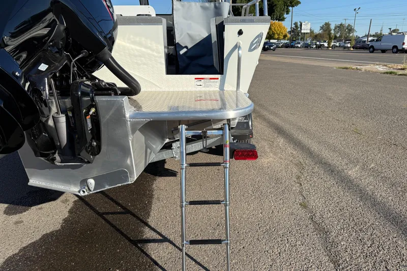 Slide: The Image of 2026 Thunder Jet 185 Luxor boat with ladder and motor, parked on pavement. - 11
