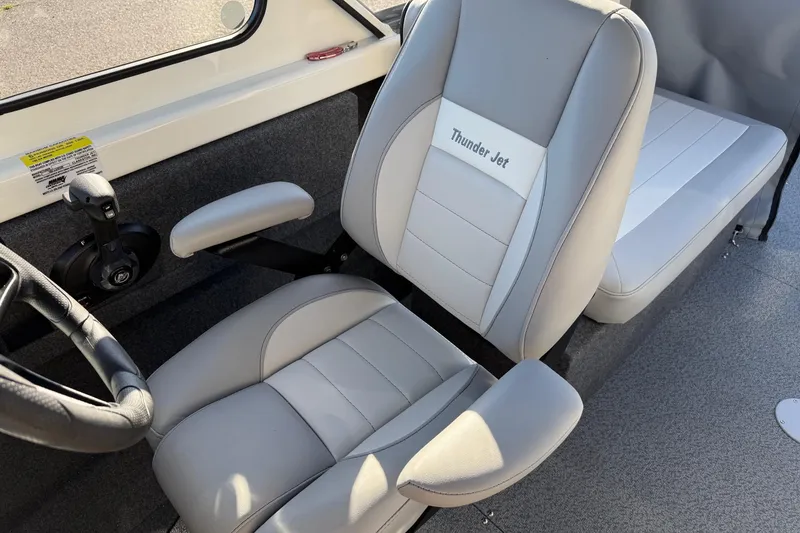 Slide: The Image of 2026 Thunder Jet 185 Luxor boat interior with gray seating and steering wheel. - 16
