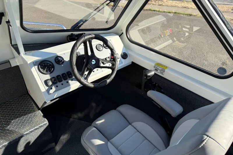 Slide: The Image of 2026 Thunder Jet 185 Luxor boat interior with steering wheel and control panel. - 17