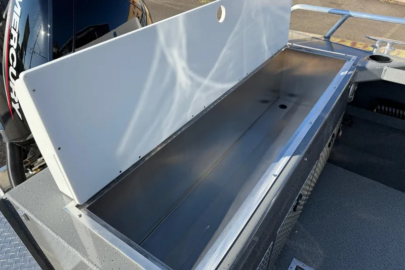 Slide: The Image of Open storage compartment on 2026 Thunder Jet 185 Luxor boat, featuring a Mercury engine. - 26