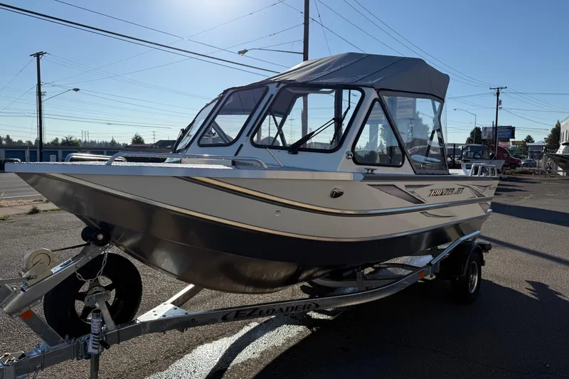 Slide: The Image of 2026 Thunder Jet 185 Luxor boat on trailer, parked outdoors under clear sky. - 5