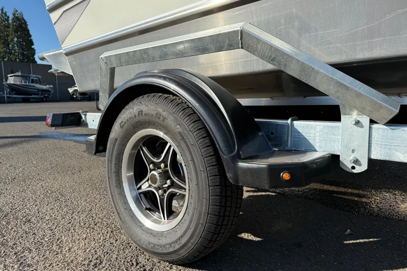 Slide: The Image of Trailer wheel of 2026 Thunder Jet 185 Luxor boat, parked on asphalt. - 9