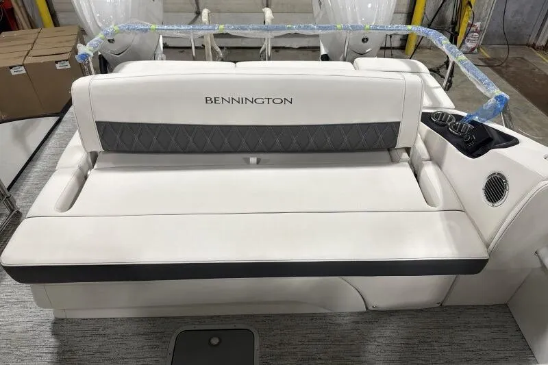 Slide: The Image of 2025 Bennington 27QXSBWAT2 boat interior with white seating and cup holders. - 10