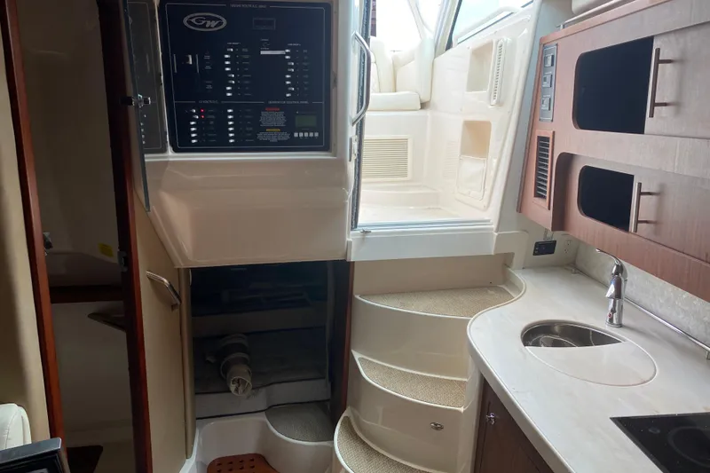 Slide: The Image of Interior of 2022 Grady-White Express 370 boat with control panel and kitchenette. - 11