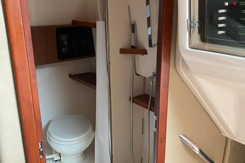 Slide: The Image of 2022 Grady-White Express 370 boat bathroom with toilet and shower. - 15