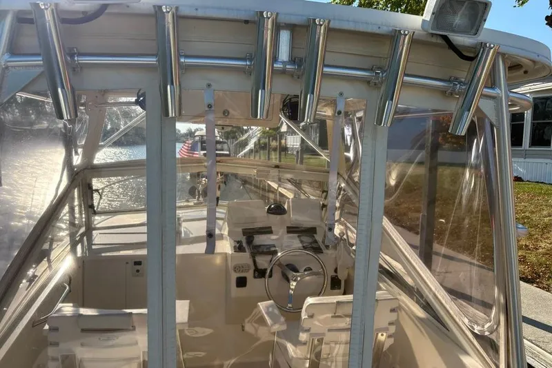 Slide: The Image of Interior view of a 2005 Carolina Classic 25 boat with clear enclosures and rod holders. - 10