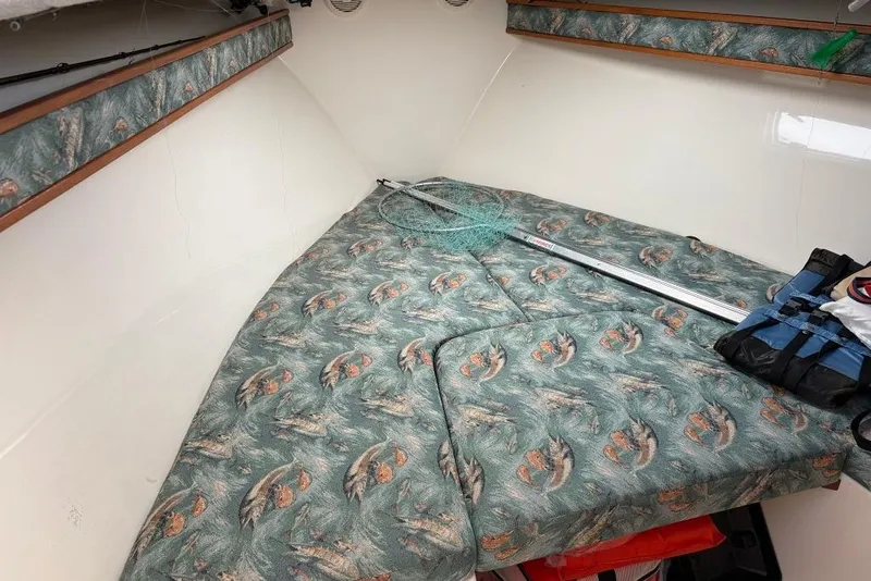 Slide: The Image of Interior cabin of a 2005 Carolina Classic 25 boat with fishing gear. - 13