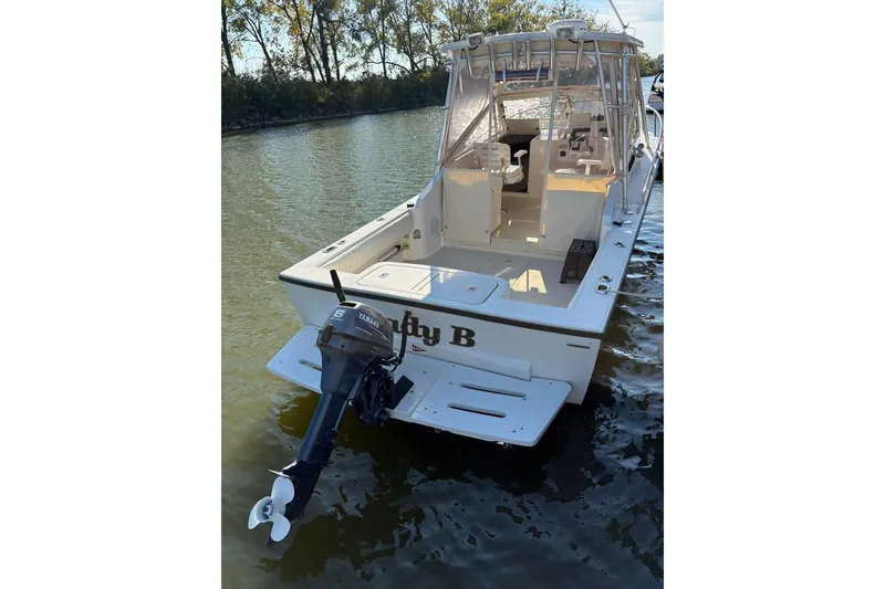 Slide: The Image of 2005 Carolina Classic 25 boat with Yamaha outboard motor on calm water. - 2