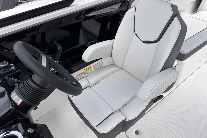 Slide: The Image of 2025 Yamaha Boats AR250 cockpit with sleek steering wheel and comfortable captain's chair. - 10