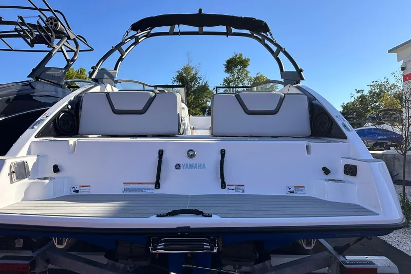 Slide: The Image of 2025 Yamaha Boats AR250, rear view, showcasing sleek design and spacious seating. - 20