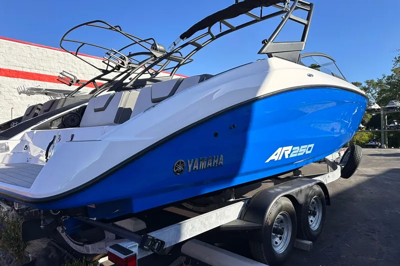 Slide: The Image of 2025 Yamaha AR250 boat in blue on a trailer, showcasing sleek design and modern features. - 22